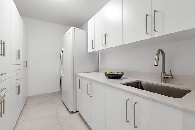 720 Clinton St Unit 6-03, Hoboken, NJ 07030 - kitchen featuring light countertops, white cabinetry, freestanding refrigerator, and light tile patterned flooring