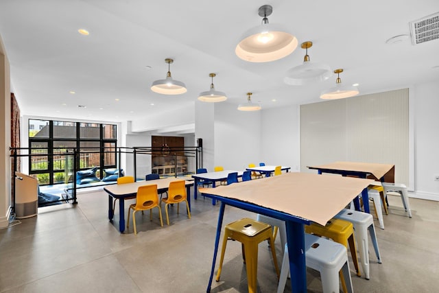 720 Clinton St Unit 6-03, Hoboken, NJ 07030 - dining area with finished concrete flooring, recessed lighting, and a wall of windows