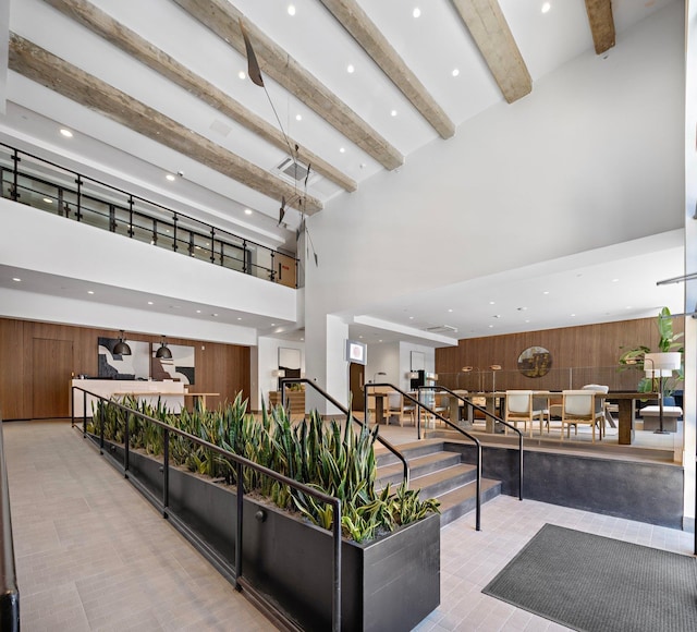 720 Clinton St Unit 6-03, Hoboken, NJ 07030 - building lobby featuring a high ceiling, beamed ceiling, recessed lighting, and wood walls