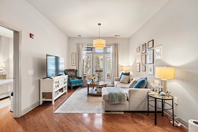 living room with french doors and hardwood / wood-style flooring