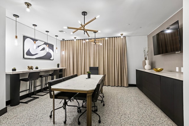 dining area with an inviting chandelier