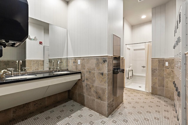 bathroom featuring sink, tile walls, and tile patterned floors