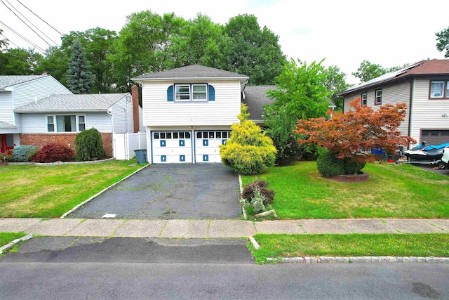 view of front of property featuring a garage and a front yard