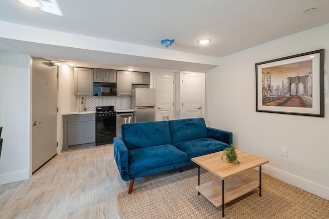 living room featuring light hardwood / wood-style floors and sink