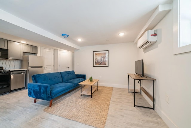 living room with light hardwood / wood-style flooring and a wall mounted air conditioner