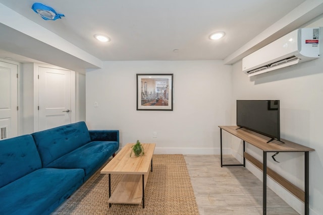 living room featuring light hardwood / wood-style flooring and an AC wall unit