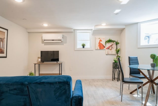 bedroom with a wall mounted AC and light wood-type flooring