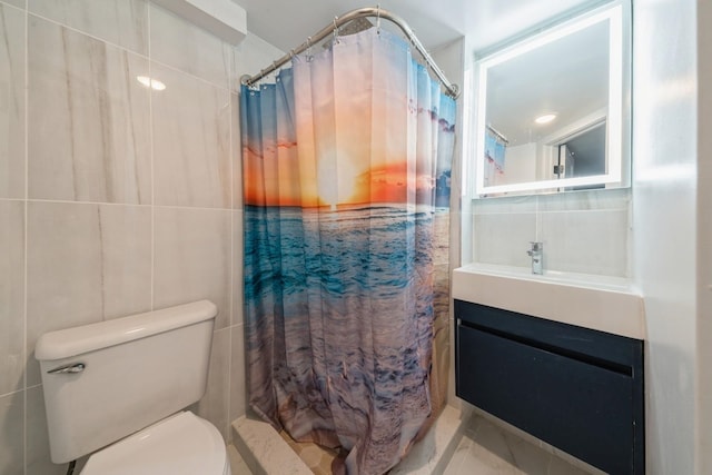 bathroom featuring tile walls, vanity, and toilet