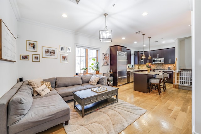 living room featuring crown molding and light hardwood / wood-style flooring