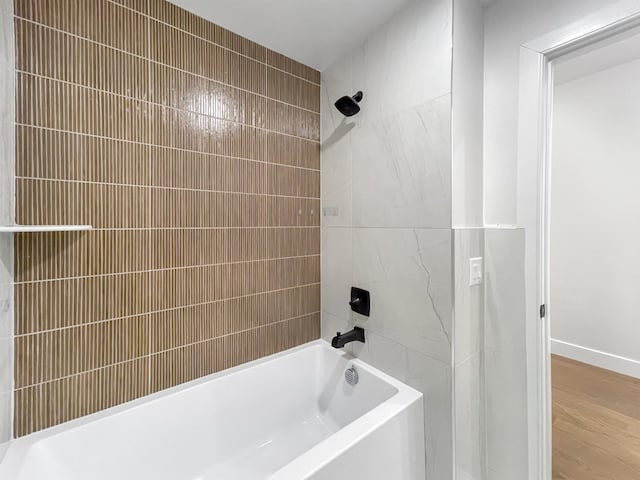 285 Lembeck Ave Unit 1, Jersey City, NJ 07305 - bathroom featuring baseboards, bathing tub / shower combination, and wood finished floors