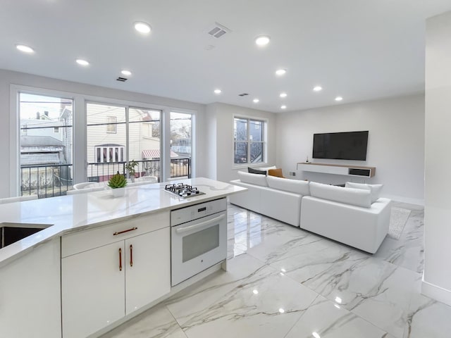 285 Lembeck Ave Unit 1, Jersey City, NJ 07305 - kitchen with stainless steel gas cooktop, oven, visible vents, marble finish floor, and recessed lighting