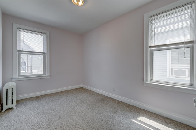carpeted spare room with baseboards
