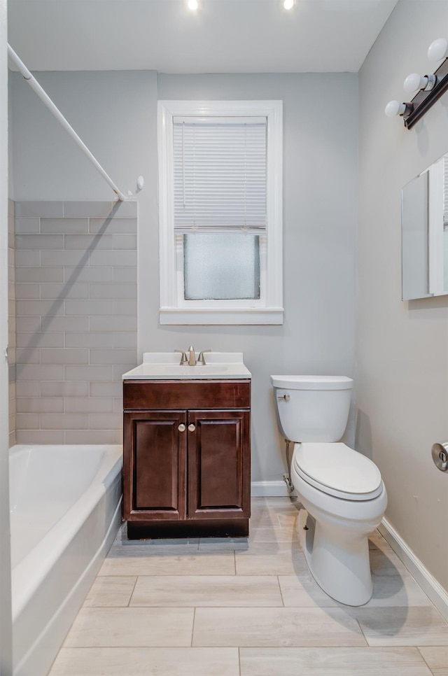 bathroom featuring toilet, baseboards, tub / shower combination, vanity, and recessed lighting