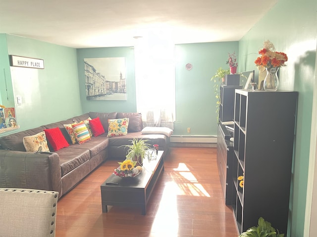 living room featuring baseboard heating and wood-type flooring