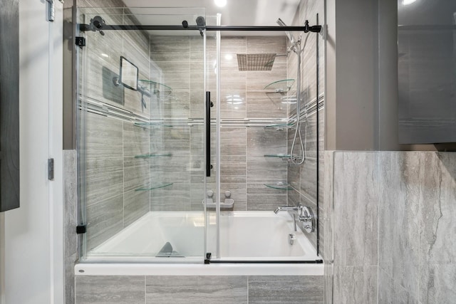 bathroom featuring shower / bath combination with glass door