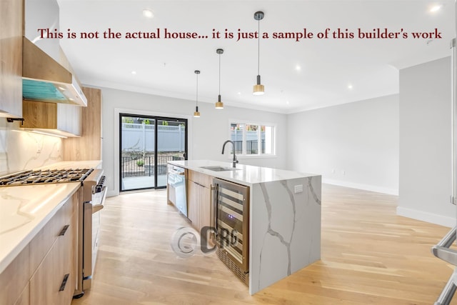 kitchen with light stone countertops, sink, hanging light fixtures, beverage cooler, and high end stainless steel range