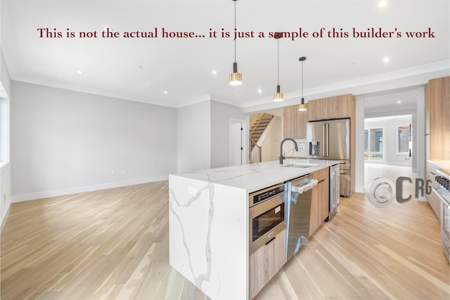 kitchen with pendant lighting, a kitchen island with sink, light wood-type flooring, light stone countertops, and stainless steel appliances