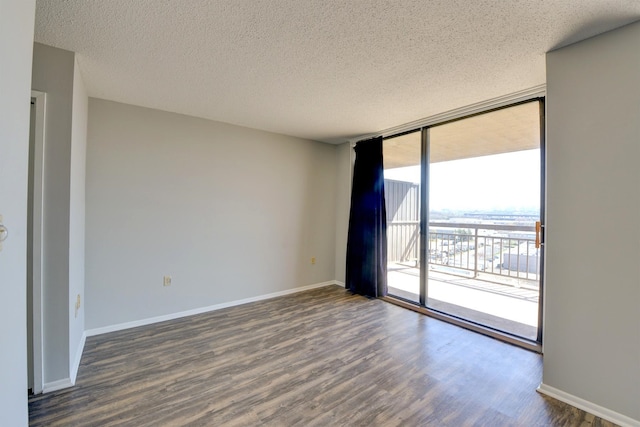 1011 Harmon Cv Unit 1011, Secaucus, NJ 07094 - spare room featuring a textured ceiling, expansive windows, wood finished floors, and baseboards