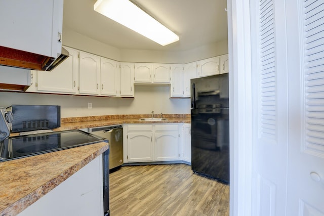 1011 Harmon Cv Unit 1011, Secaucus, NJ 07094 - kitchen with freestanding refrigerator, dishwasher, light wood-style flooring, white cabinets, and a sink
