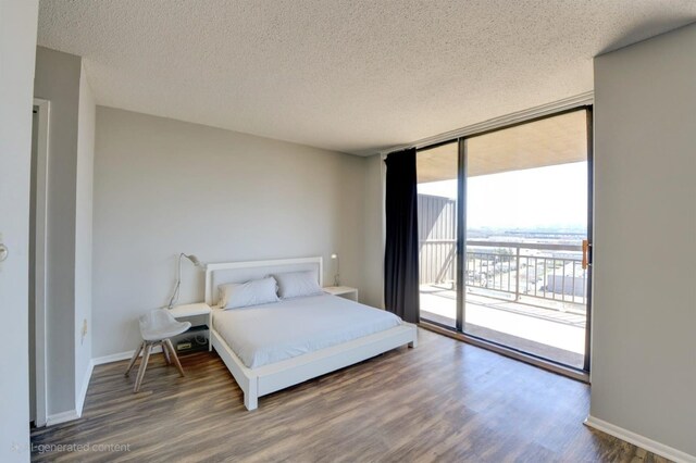 1011 Harmon Cv Unit 1011, Secaucus, NJ 07094 - bedroom featuring a textured ceiling, access to outside, floor to ceiling windows, wood finished floors, and baseboards