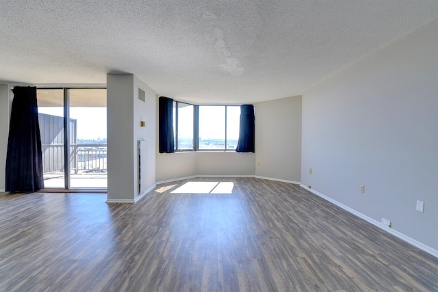 1011 Harmon Cv Unit 1011, Secaucus, NJ 07094 - unfurnished room with a textured ceiling, dark wood-type flooring, and baseboards
