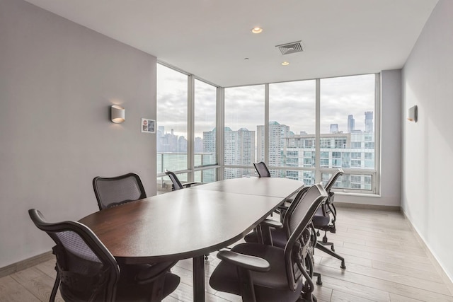 dining room with expansive windows and light wood-type flooring