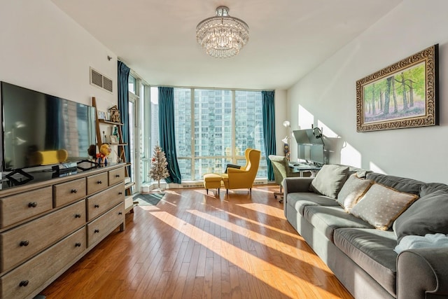 sitting room featuring dark hardwood / wood-style flooring, expansive windows, and a chandelier