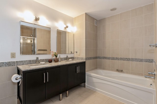 bathroom with tile walls, vanity, tile patterned floors, and independent shower and bath