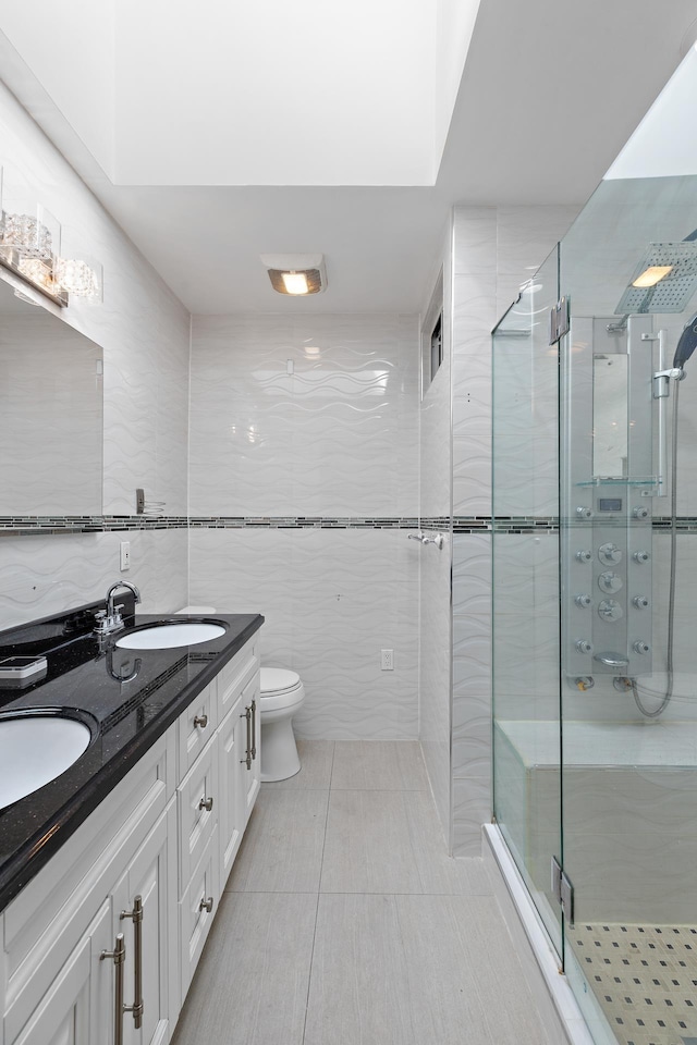 full bathroom with a stall shower, a sink, tile walls, and toilet