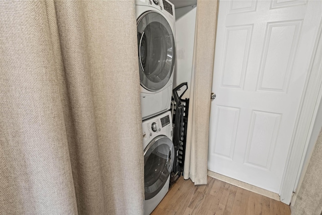 205 10th St Unit 3G, Jersey City, NJ 07302 - laundry room with stacked washer and clothes dryer and wood finished floors