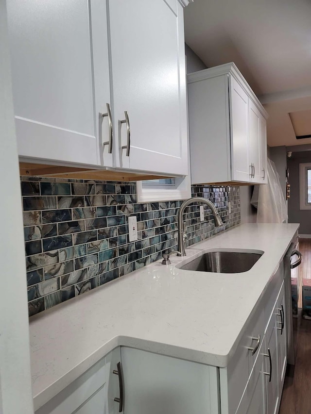 kitchen featuring decorative backsplash, sink, white cabinets, and dark hardwood / wood-style floors