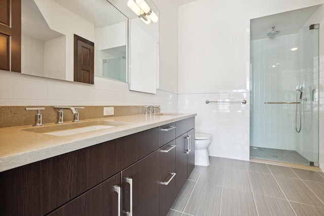 bathroom featuring tile walls, tile patterned flooring, vanity, toilet, and a shower with door
