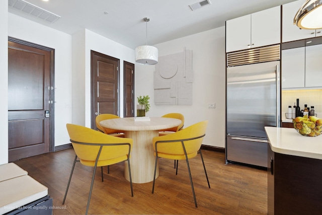 dining area with dark hardwood / wood-style flooring