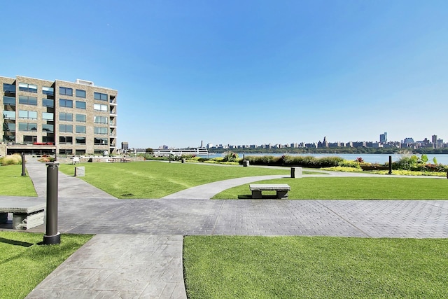 view of community with a water view and a yard