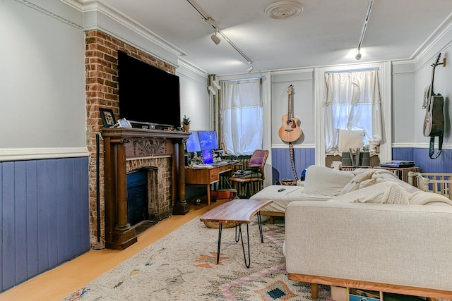 living room with rail lighting and a brick fireplace