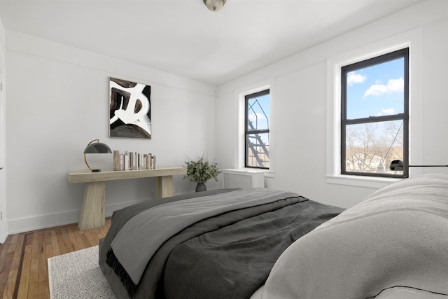 bedroom with wood finished floors and baseboards