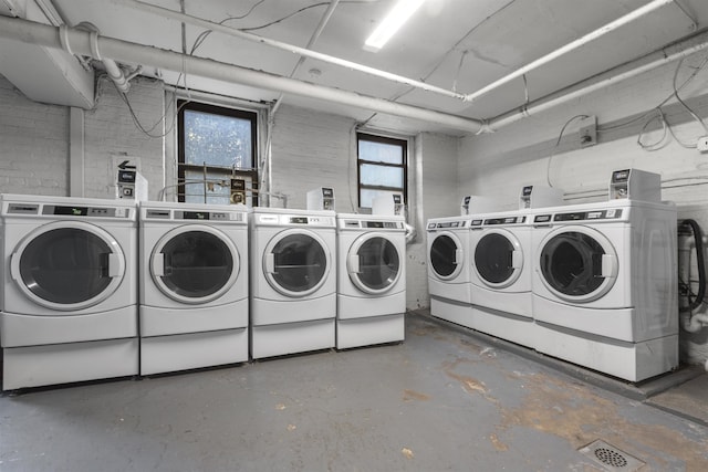 shared laundry area with independent washer and dryer