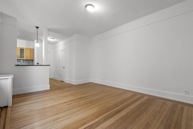 spare room with light wood-style flooring and baseboards