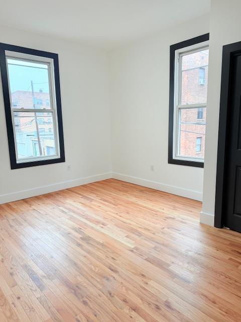 530 45th St, Union City, NJ 07087 - spare room featuring light wood-style floors and baseboards