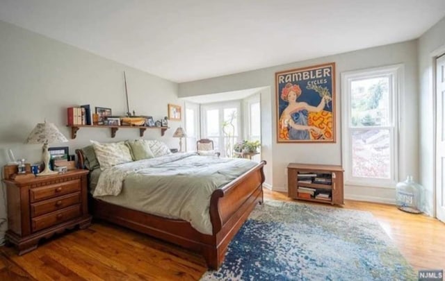 bedroom with hardwood / wood-style flooring