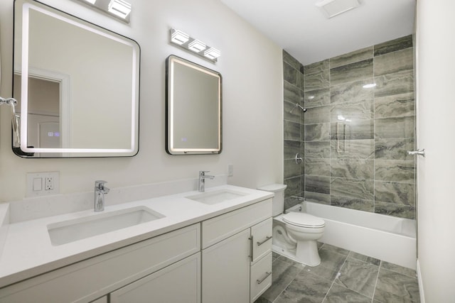 full bath with toilet, double vanity, bathtub / shower combination, and a sink