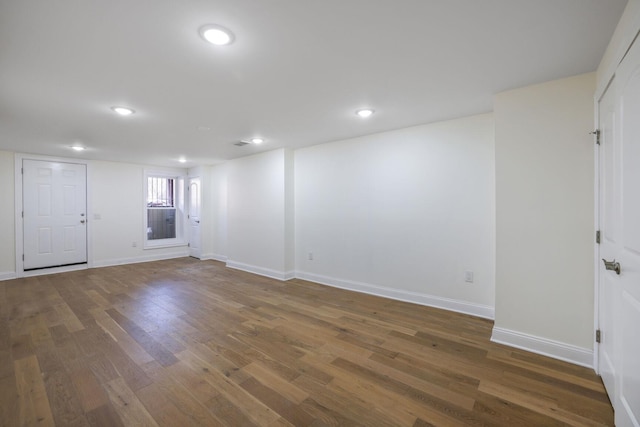 empty room featuring recessed lighting, baseboards, and wood finished floors