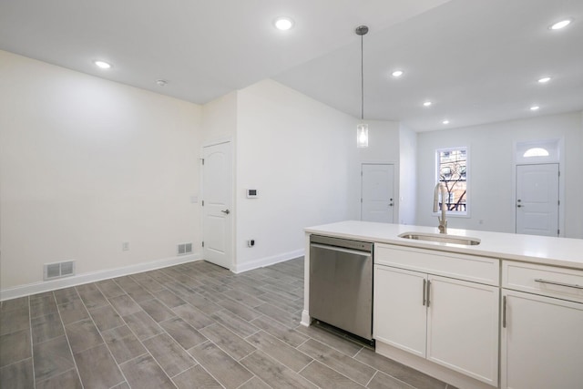 kitchen featuring a sink, visible vents, white cabinetry, light countertops, and stainless steel dishwasher