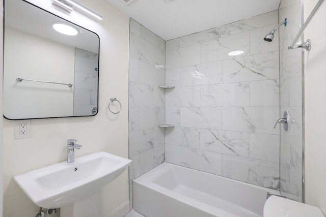 full bathroom featuring toilet, tub / shower combination, and a sink