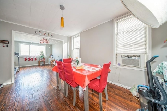 dining room featuring cooling unit, dark hardwood / wood-style flooring, and ornamental molding