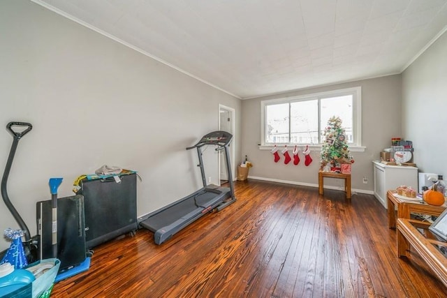 exercise area with crown molding and dark hardwood / wood-style floors