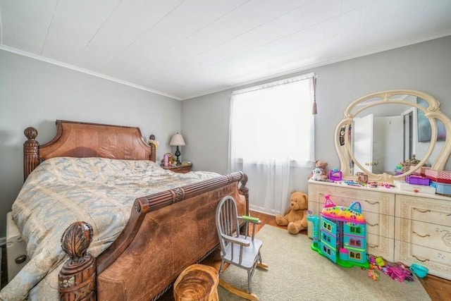 bedroom featuring ornamental molding and hardwood / wood-style flooring