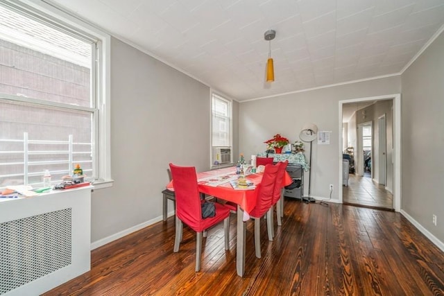 dining room with ornamental molding, dark wood-type flooring, and radiator