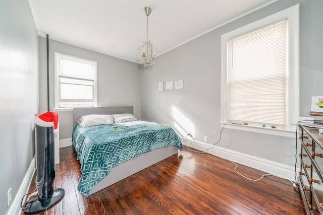 bedroom featuring a chandelier and dark hardwood / wood-style floors