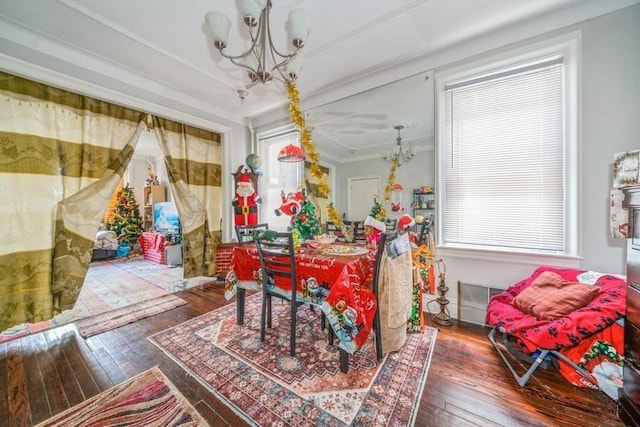 interior space featuring a notable chandelier, ornamental molding, plenty of natural light, and wood-type flooring